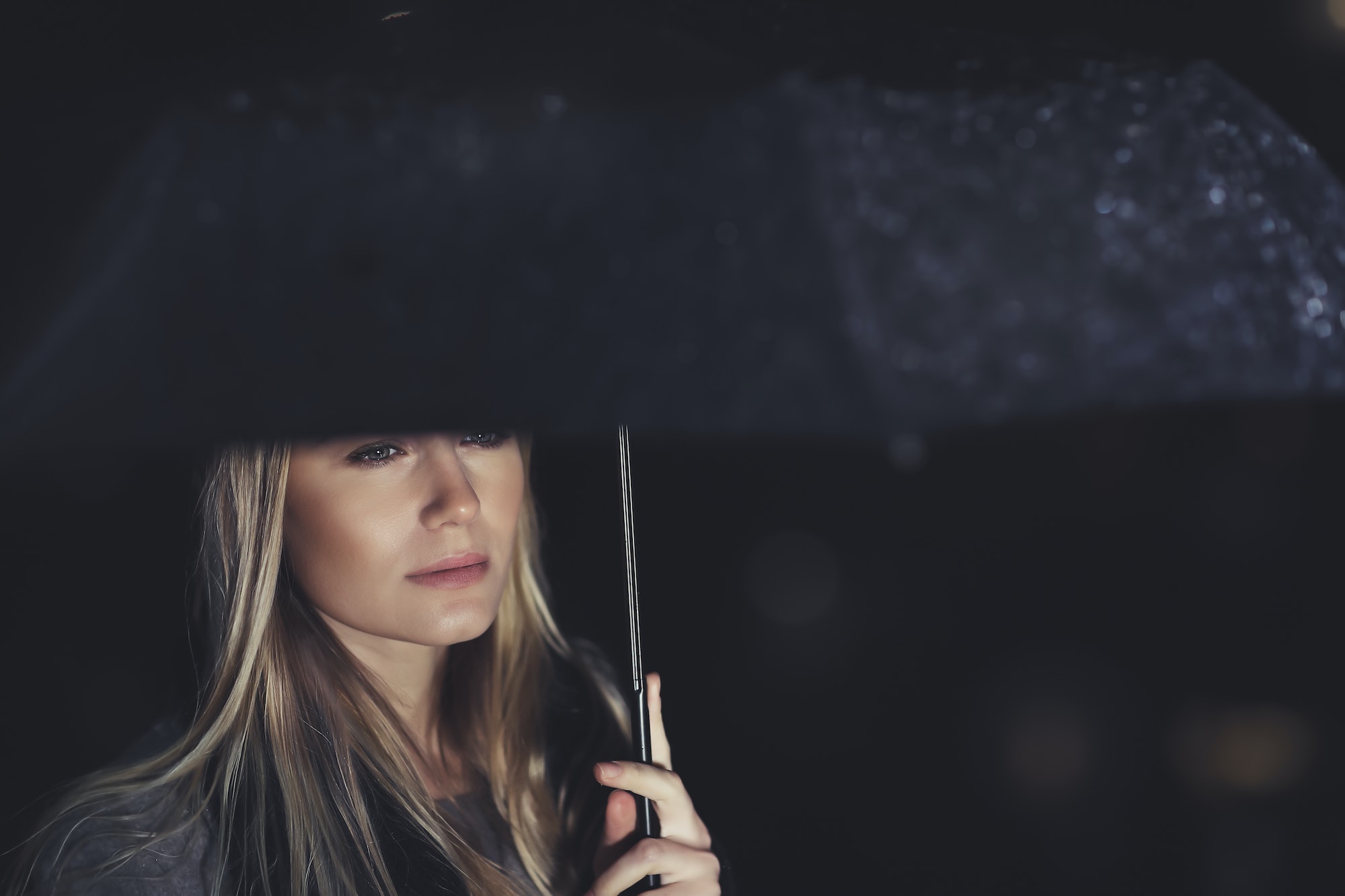 Beautiful sad woman under the rain