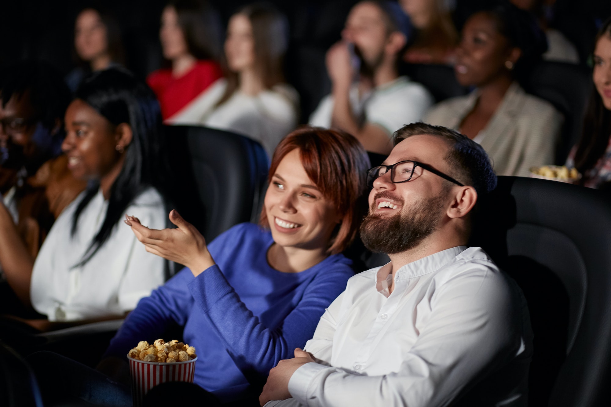 Couple discussing film in movie theater