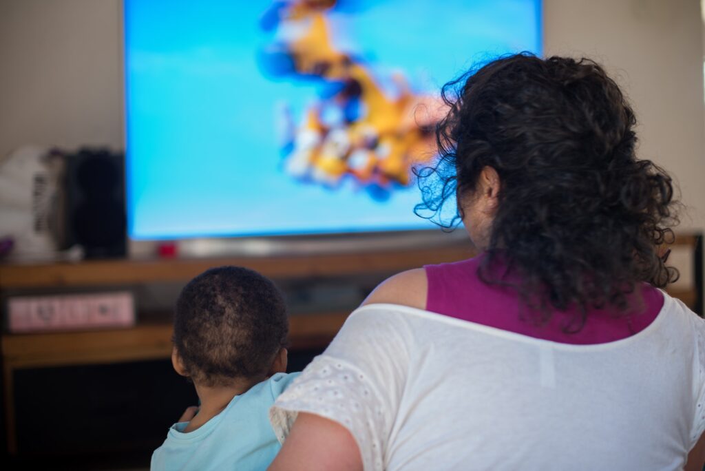 Mother and child watching television