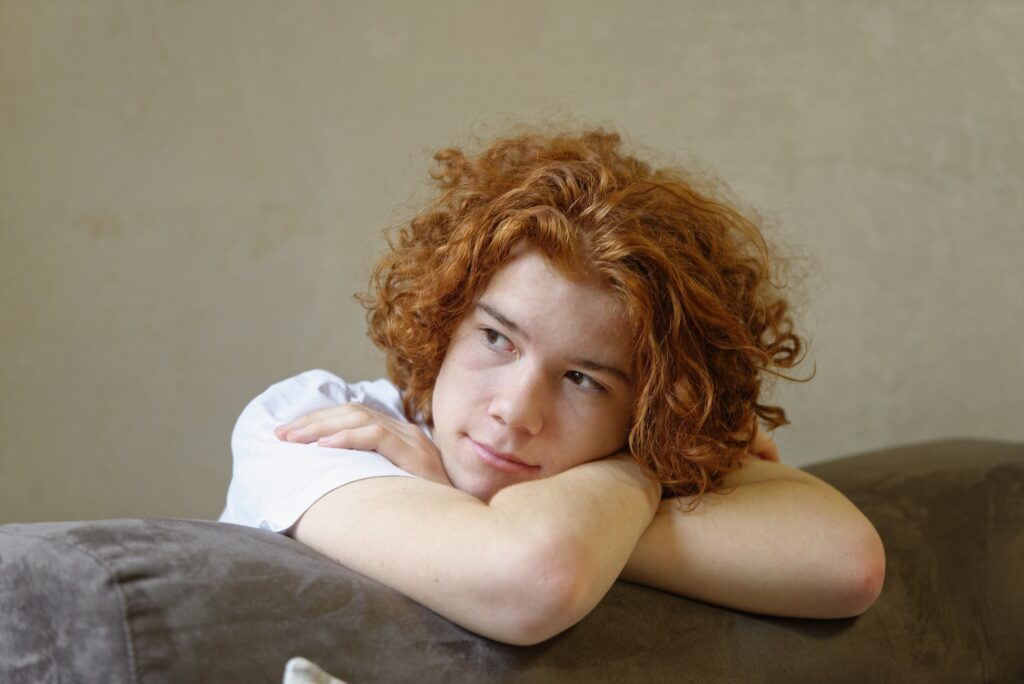 Portrait of pensive redheaded teenage boy