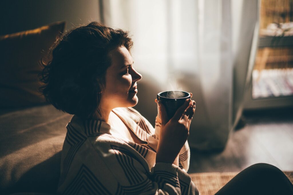 Woman drinking coffee or tea and having a quiet moment.